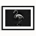 Framed wall art featuring a vibrant flamingo design, presented in a sleek black frame with a white mat, ideal for adding a tropical touch to home decor.
