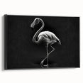 Framed canvas wall art showcasing a vibrant flamingo design, featuring bold pink and black colors, set against a minimalist background for modern decor.