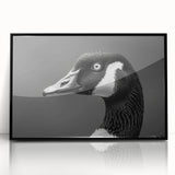 Framed wall art featuring a stylized goose design, showcased in a sleek black frame with acrylic glass, perfect for modern home decor.