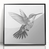 Framed acrylic wall art featuring a vibrant hummingbird design in shades of blue and green, set against a sleek black frame, perfect for modern decor.