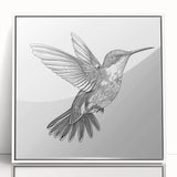 Framed acrylic wall art showcasing a vibrant hummingbird design with intricate details, set against a sleek white background, perfect for nature-themed decor.