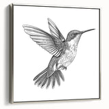 Framed wall art featuring a silver-hued hummingbird design on canvas, showcasing intricate details and vibrant colors, ideal for home decor.
