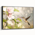 Framed wall art featuring a vibrant hummingbird design on a textured canvas, presented in a sleek black frame, perfect for modern home decor or nature enthusiasts.