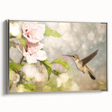 Framed wall art featuring a vibrant hummingbird design on a textured canvas with a sleek silver frame, perfect for adding a touch of nature to any decor.