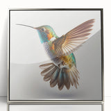 Framed wall art showcasing a vibrant hummingbird design with a silver-acrylic finish, perfect for adding a touch of elegance to any room decor.
