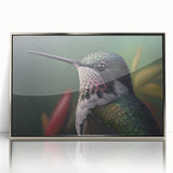Framed acrylic wall art showcasing an elegant hummingbird design in vibrant colors, featuring a sleek silver frame, ideal for enhancing modern home decor.