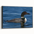 Framed wall art featuring a serene loon design on a black canvas, showcasing its elegant profile against a sleek side view, perfect for modern home decor.