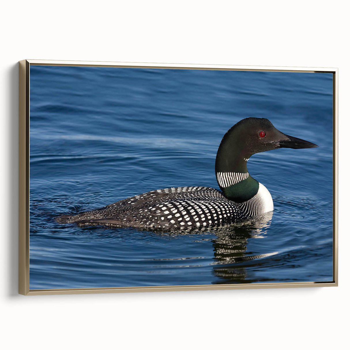 Framed wall art featuring a serene loon design in gold accents, set against a textured canvas background, perfect for enhancing living spaces with nature-inspired decor.