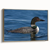Framed wall art featuring a serene loon design in gold accents, set against a textured canvas background, perfect for enhancing living spaces with nature-inspired decor.