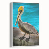 Framed canvas wall art depicting a side view of a pelican in a minimalist design, featuring soft white tones and elegant lines, ideal for coastal decor.