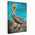 Stretched canvas wall art featuring a colorful pelican design against a serene blue background, ideal for coastal decor and bird enthusiasts.