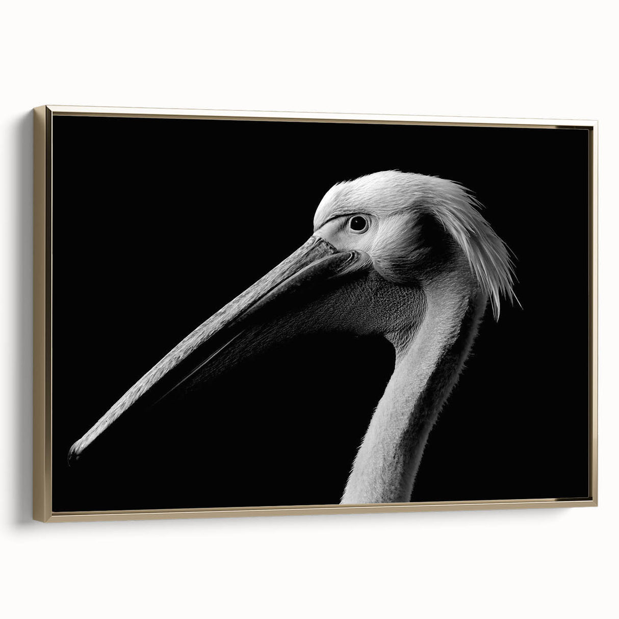 Framed wall art featuring a side view of a golden pelican design on a textured canvas, set against a sleek, modern background for elegant home decor.