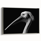 Framed wall art showcasing a side view of a silver pelican design on canvas, ideal for coastal home decor and bird enthusiasts, adding elegance to any room.