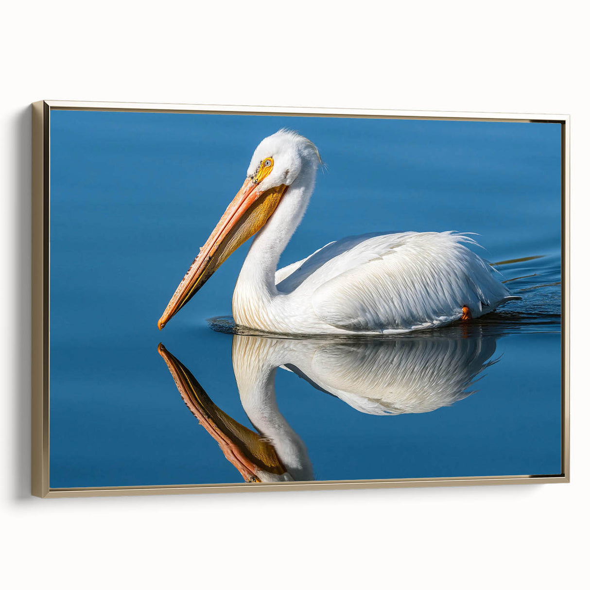 Framed canvas wall art featuring a side view of a pelican design, with elegant gold accents and a textured finish, perfect for coastal-themed decor.