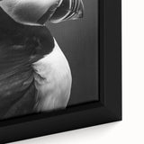 Close-up of a framed canvas wall art featuring a vibrant puffin design, showcasing bright colors and intricate details, ideal for coastal-themed decor.