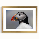 Framed wall art showcasing a vibrant puffin design with a gold mat, perfect for coastal-themed decor. The elegant frame enhances any interior space.