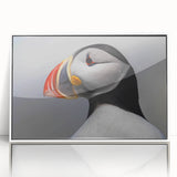 Framed wall art featuring a puffin design with vibrant colors, set against a sleek white background, ideal for nature lovers and home decor enthusiasts.