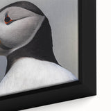 Close-up of a framed canvas wall art featuring a vibrant puffin design with intricate details, perfect for adding a coastal theme to home decor.