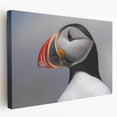 Stretched canvas art showcasing a vibrant puffin design in bright colors, ideal for coastal decor. Side view highlights the textured finish and quality craftsmanship, perfect for enhancing any living space.