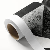 Black and white abstract wall art design on rolled canvas, showcasing bold geometric shapes and textures, ideal for modern home decor.