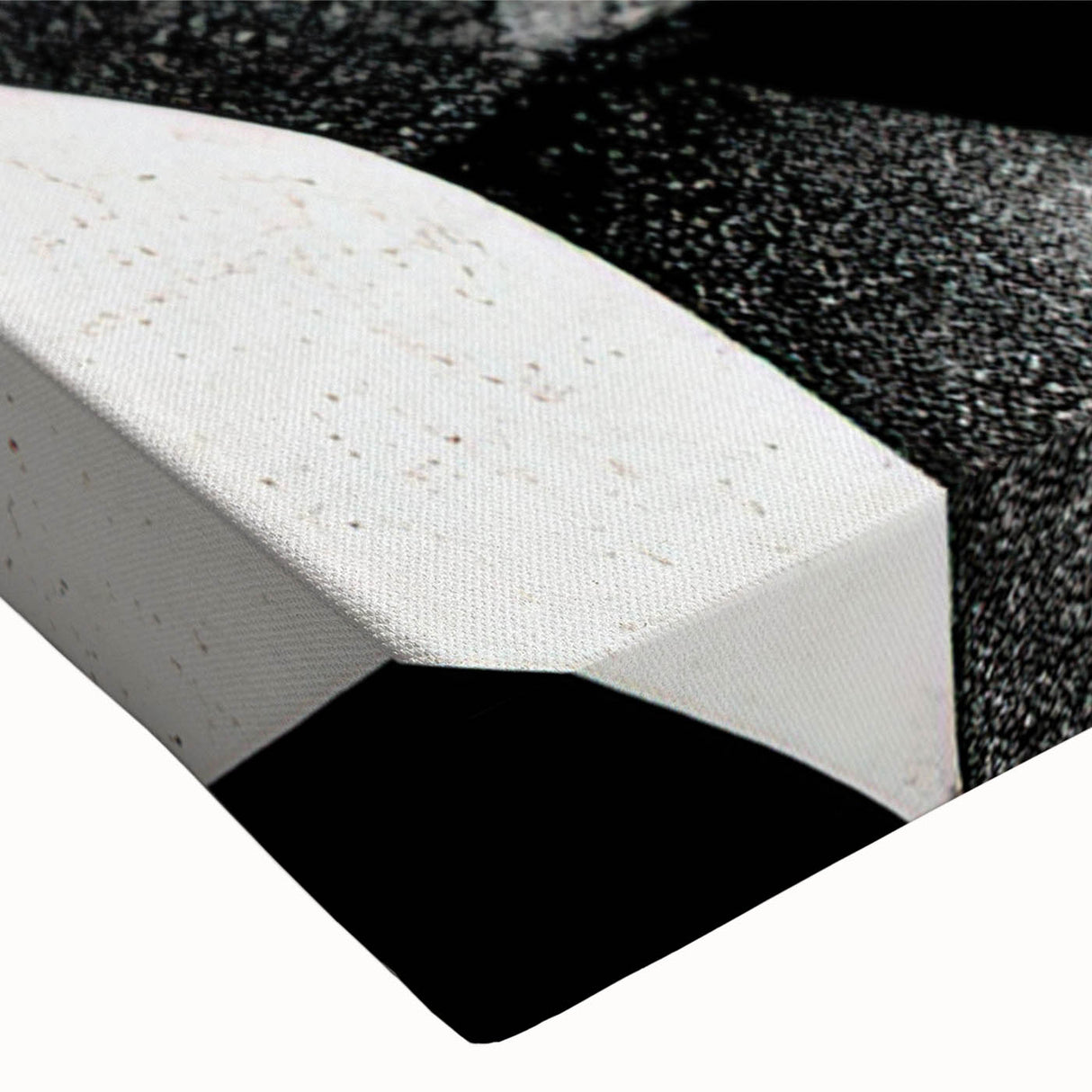 Close-up of a black and white abstract design on stretched canvas wall art, showcasing intricate patterns and textures ideal for modern decor.