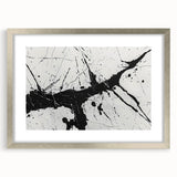 Framed black and white abstract wall art featuring geometric shapes and patterns, set in a sleek silver frame with a white mat.