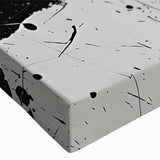 Close-up of a black and white abstract design wall art piece on stretched canvas, showcasing intricate patterns and textures for modern decor.