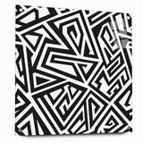 Abstract black and white wall art design displayed in a stylish acrylic glass frame, showcasing modern aesthetics and sleek pins for mounting.