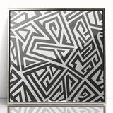 Framed black and white abstract wall art design showcasing fluid shapes and lines in a sleek silver frame, ideal for modern decor.