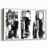Framed black-and-white abstract wall art featuring geometric shapes and lines, set in a sleek silver frame, adding modern elegance to decor.