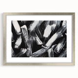 Abstract black and white wall art design in a silver frame, showcasing geometric patterns and an elegant mat for a modern decor accent.