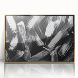 Framed black and white abstract wall art featuring geometric shapes and lines, accented with a gold border, perfect for modern decor.