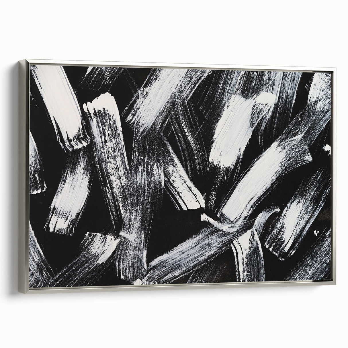 Framed black and white abstract wall art with a silver frame, showcasing dynamic geometric patterns and elegant design for modern decor.