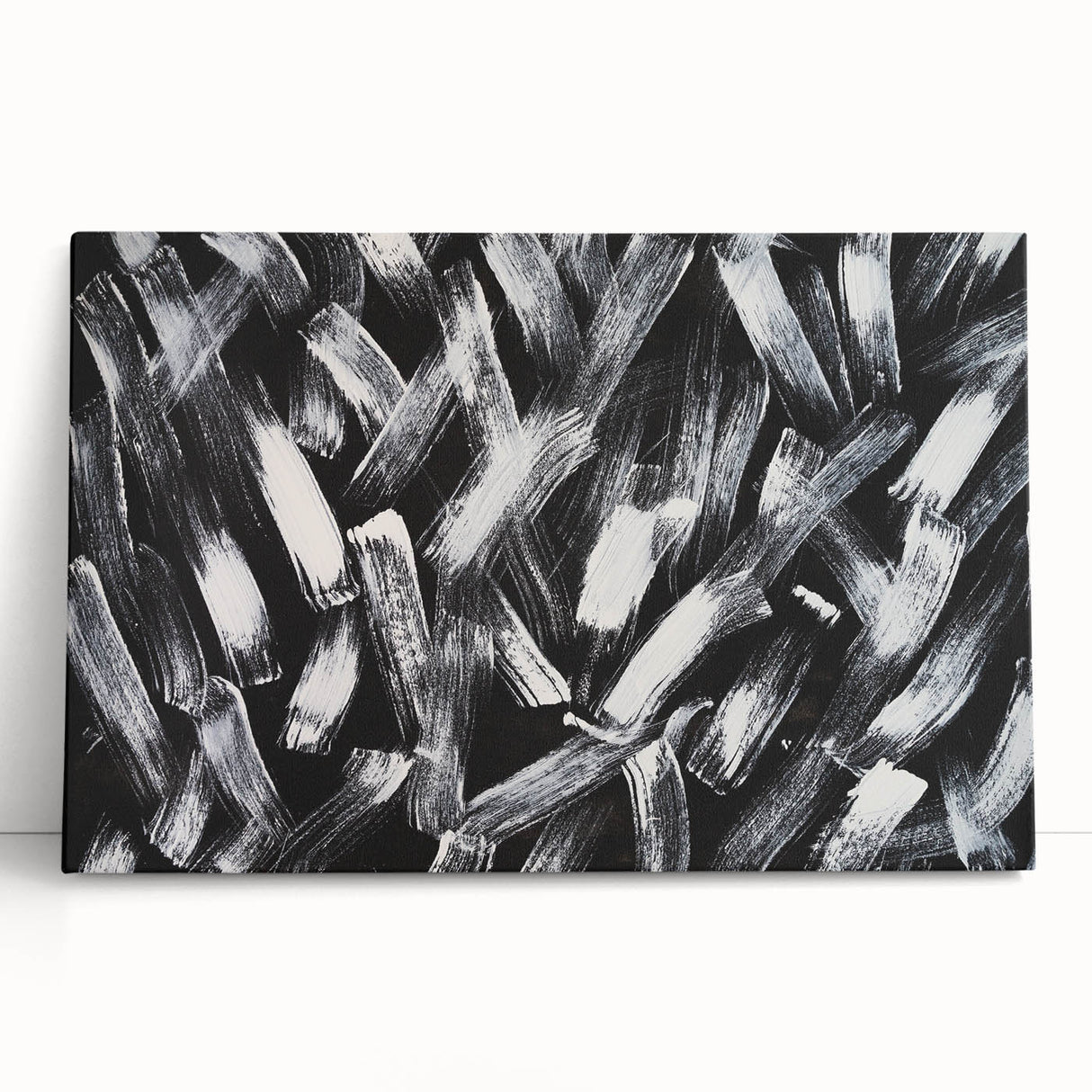 Abstract black and white wall art collection on stretched canvas, showcasing dynamic shapes and lines, perfect for modern decor.