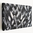 Stretched canvas displaying a black and white abstract wall art design, showcasing fluid shapes and textures, ideal for modern home decor.