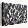 Stretched canvas displaying a black and white abstract wall art design, showcasing fluid shapes and textures, ideal for modern home decor.