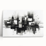 Abstract black and white stretched canvas wall art showcasing modern geometric shapes and bold lines, leaning against a neutral backdrop.