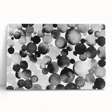 Black and white abstract wall art design on stretched canvas, leaning against a wall, showcasing elegant patterns and textures for modern decor.