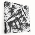 Abstract black and white wall art on stretched canvas, showcasing a modern design with dynamic shapes and textures, perfect for contemporary decor.