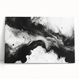 Abstract black and white wall art collection on stretched canvas, showcasing geometric shapes and textures, leaning against a neutral wall.