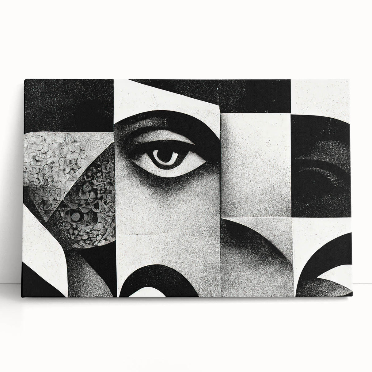 Abstract black-and-white wall art collection on stretched canvas, showcasing a modern design with bold geometric shapes, leaning against a neutral background.