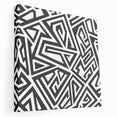 Abstract black and white wall art design on stretched canvas showcasing fluid shapes and textures, ideal for modern home decor.