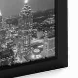 Close-up of a framed canvas featuring a textured depiction of the Atlanta skyline in black with colorful accents.