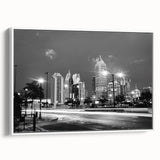 Framed canvas of vintage poster art depicting the Atlanta skyline in black with colorful accents.