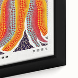 Black wall art featuring a close-up of a textured, colorful Yayoi Kusama design on a framed canvas.