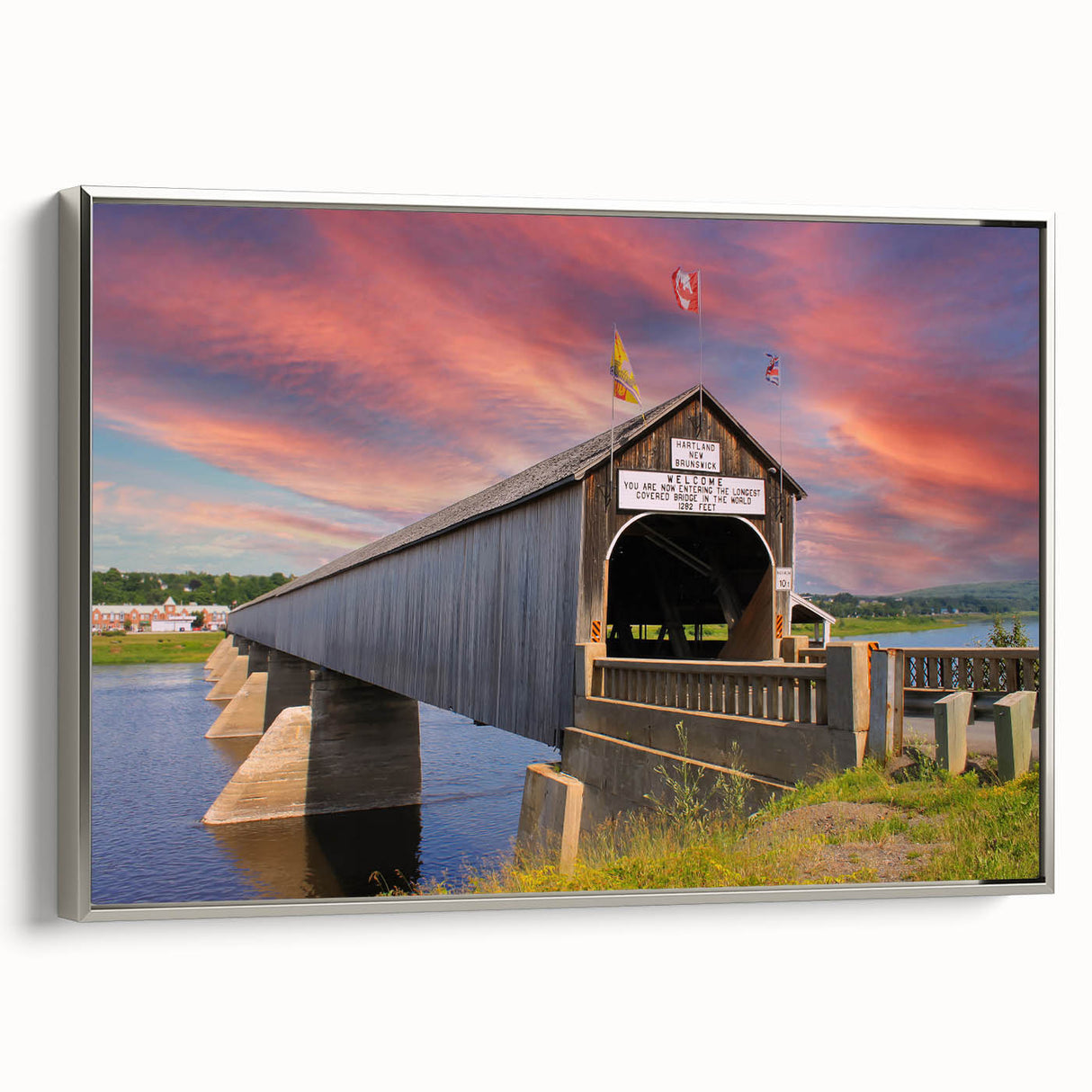 Framed canvas of a vintage-style landscape painting featuring a covered bridge, executed in muted earth tones.