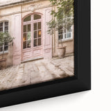 Close-up of a black framed canvas featuring a detailed, textured image of a French door in muted colors.