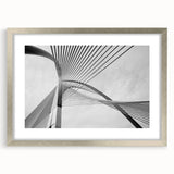 Textured abstract art print in muted gray, framed in silver, ideal for modern bedroom ambiance.