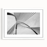 Abstract art print featuring geometric shapes in muted gray and blue tones on a framed white canvas.