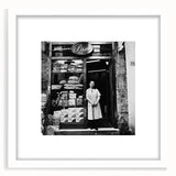 Abstract art print featuring assorted food items in vibrant colors on a white framed mat, suitable for dining room decor.